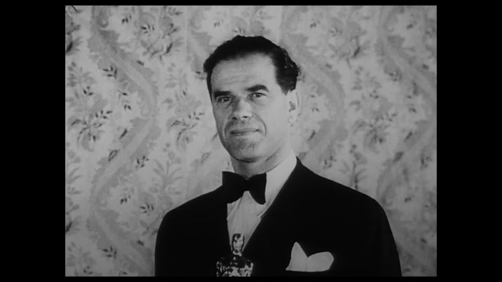 Frank Capra holding Oscar for Best Director