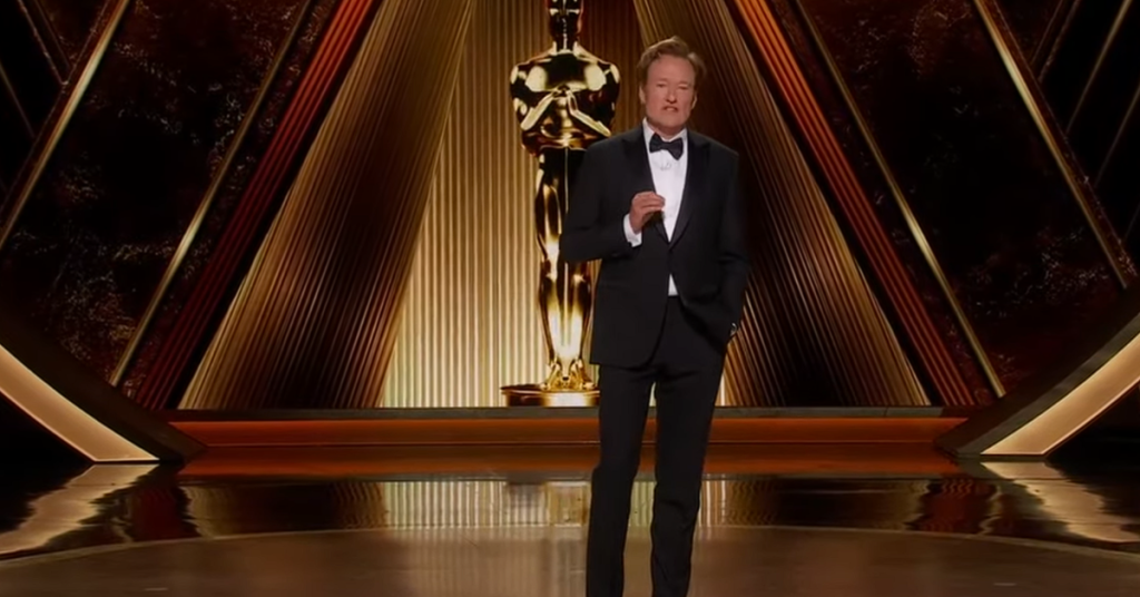 Conan while he is doing one of his comedic routines as he hosts the Oscars. 