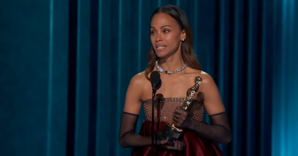 Zoe Saldana holding the Oscar and giving a heartfelt acceptance speech. 