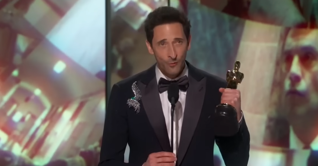 Adrien Brody holding his Oscar. 