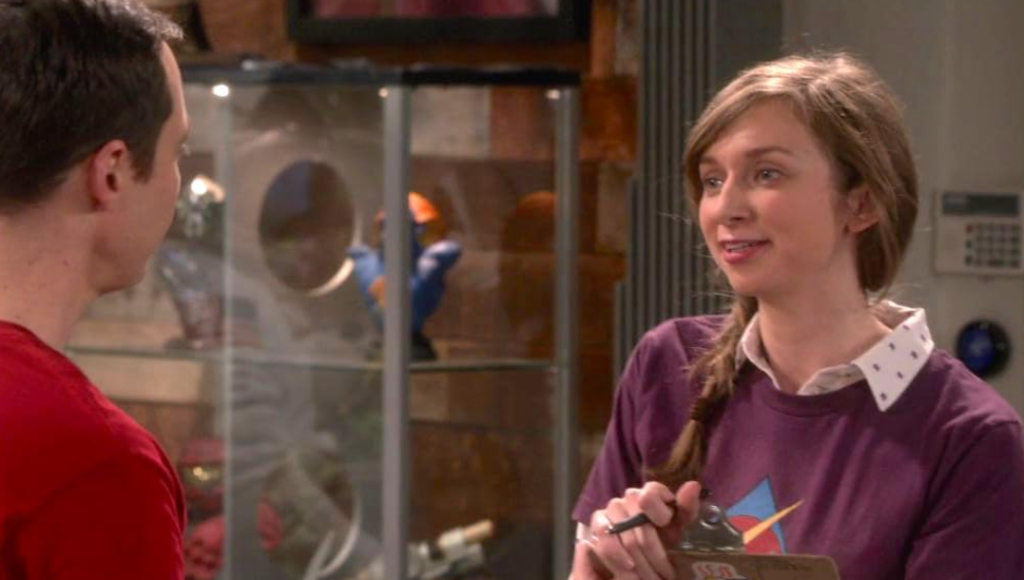 Jim Parsons as Sheldon Cooper and Lauren Lapkus as Denise in The Big Bang Theory, sharing a moment together with their signature quirky expressions