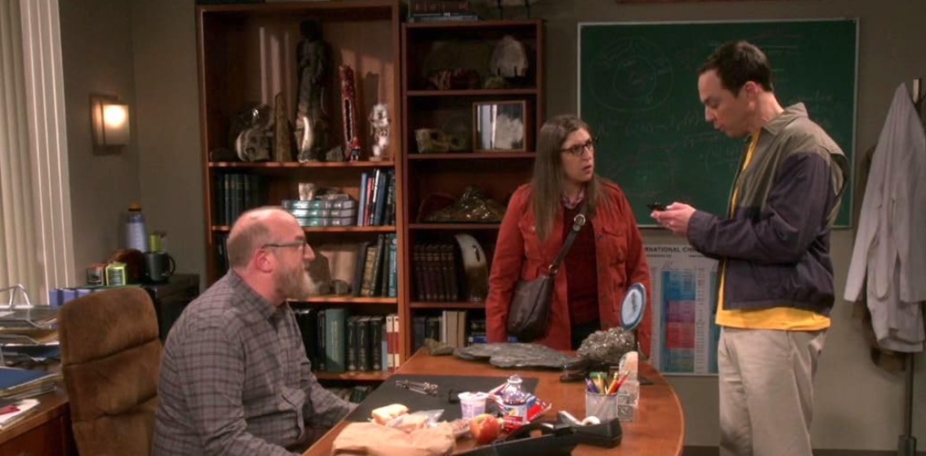 Mayim Bialik as Amy Farrah Fowler, Brian Posehn as Bert Kibbler, and Jim Parsons as Sheldon Cooper in The Big Bang Theory, capturing a funny and awkward moment.