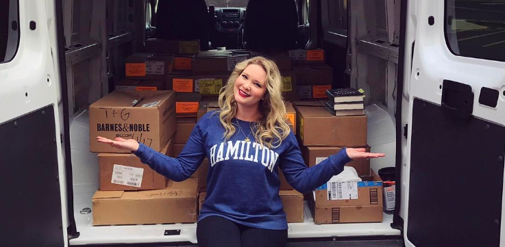 American author Sarah J. Maas showing a van full of boxes