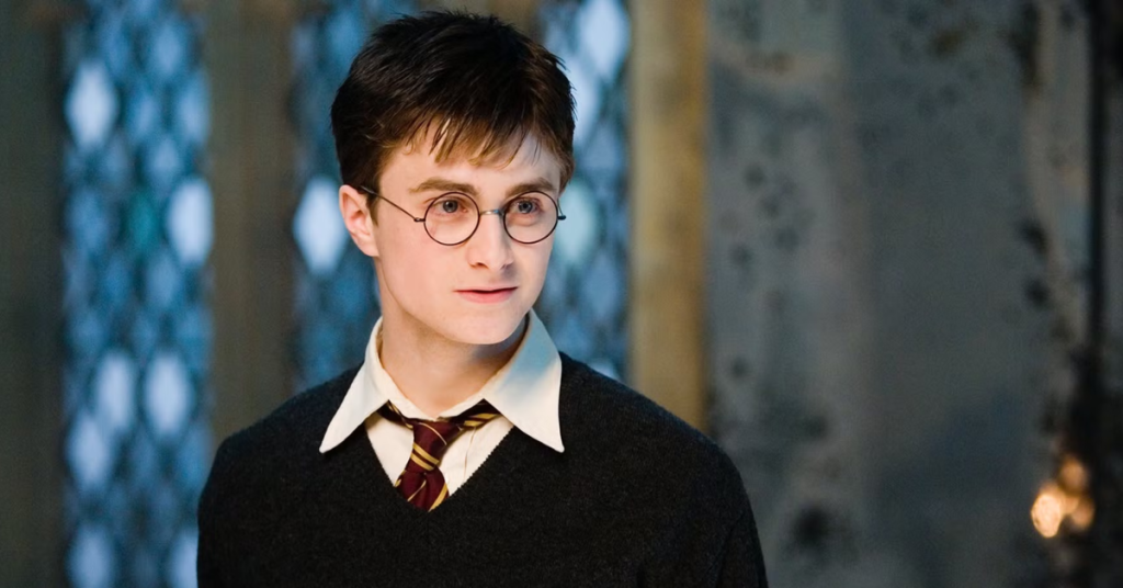 Daniel Radcliffe looking happily at someone in Harry Potter and the Order of the Phoenix