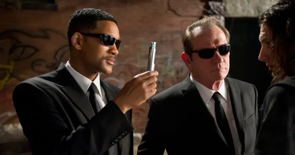 Will Smith and Clint Eastwood Almost Starred Together In One of the Greatest Movies Ever Made 1 Agent J holding a neuralyzer and wearing sunglasses alongside Agent K.