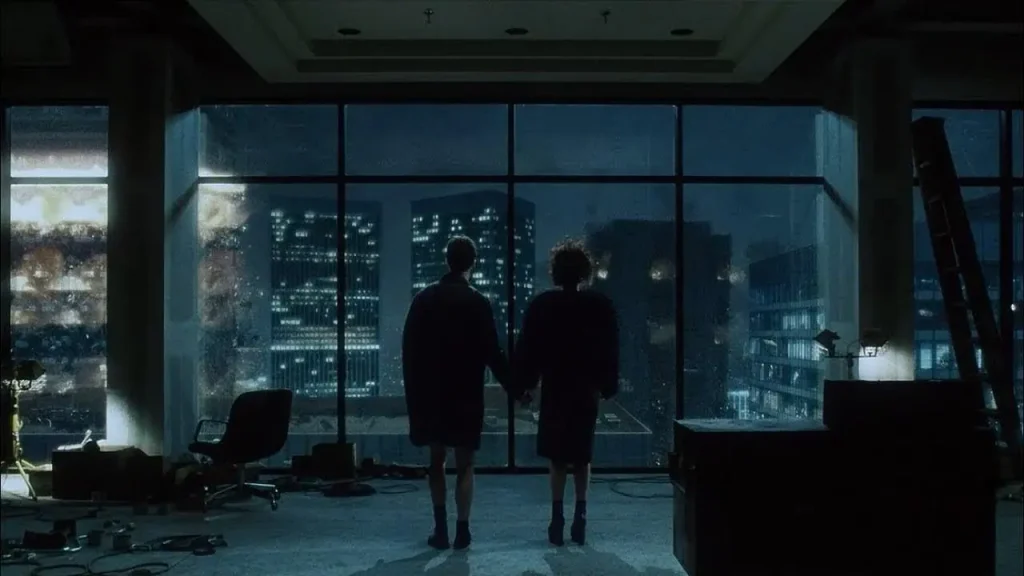 Edward Norton and Helena Bonham Carter in Fight Club staring out of glazed windows hand-in-hand.