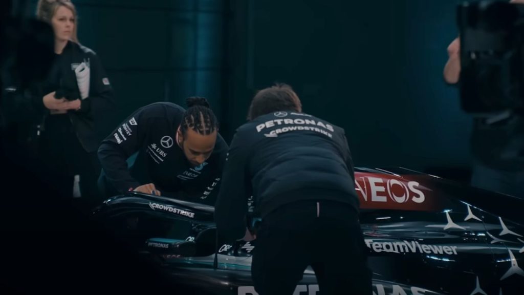 Lewis Hamilton working on his vehicle along with his team in Formula 1: Drive to Survive