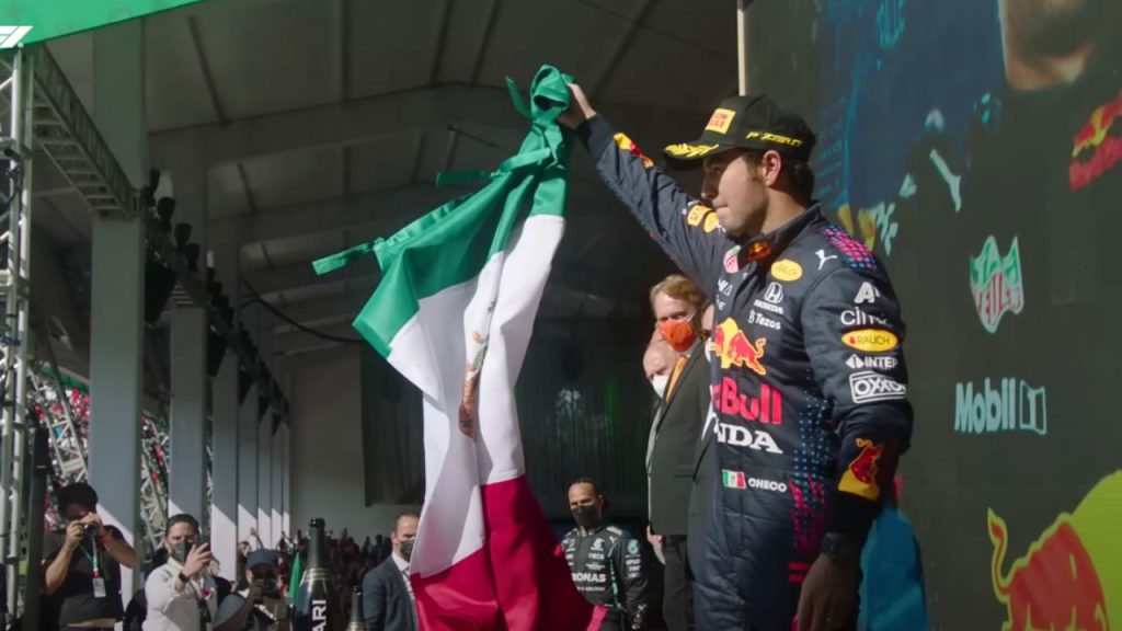 Sergio Perez lifting the flag of Mexico