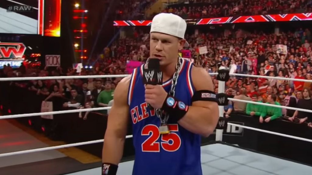 Cena wearing heavy chains and a cap backwards.