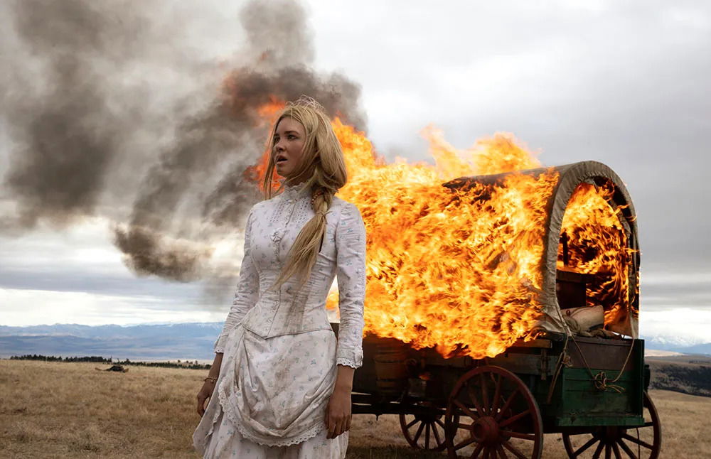 Isabel May as Elsa Dutton looking devastated as a carriage burns behind her 
