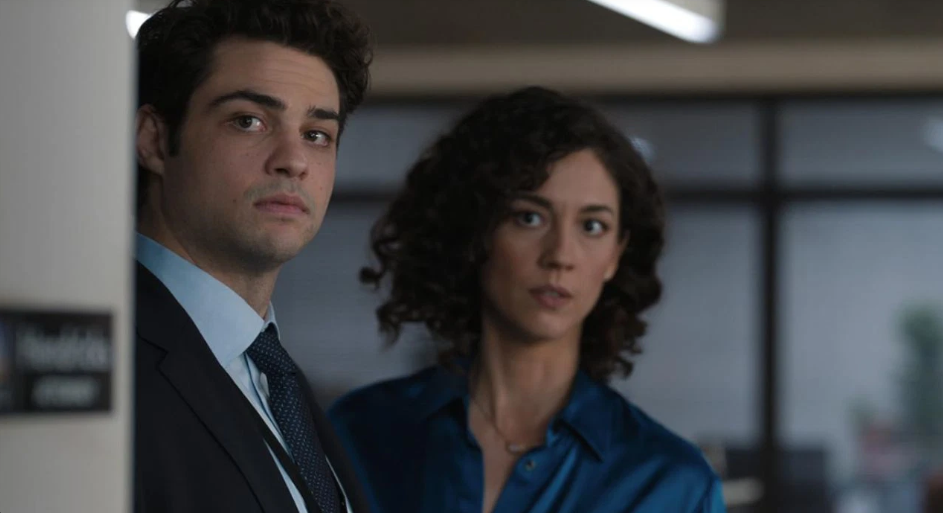 Noah Centineo and Kaylah Zander in The Recruit, both looking intense and engaged in a serious moment.