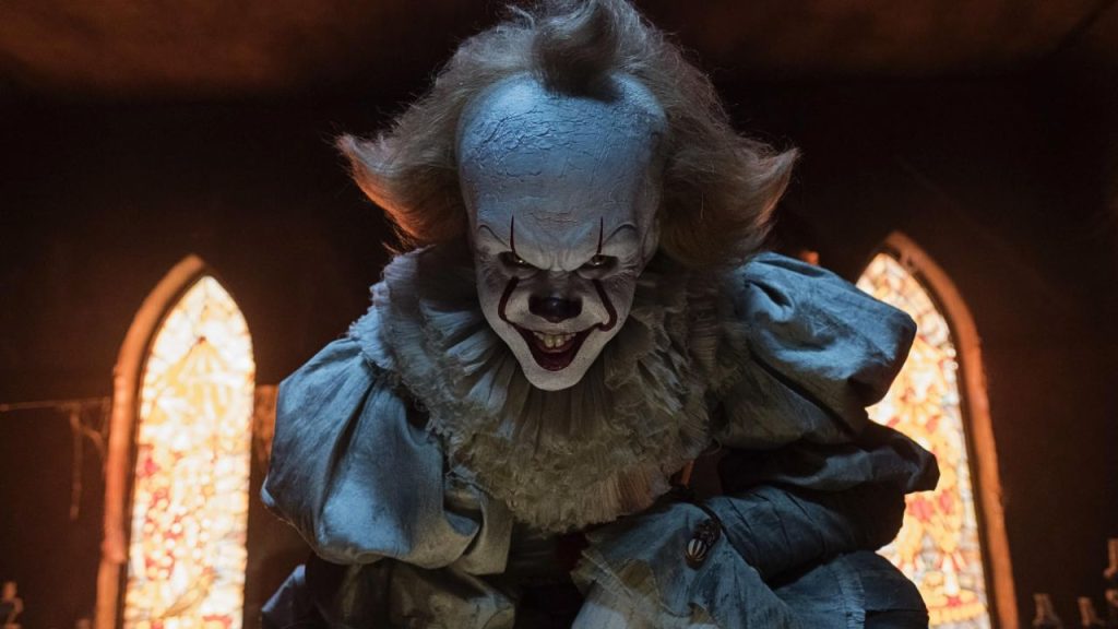 Bill Skarsgård smiling as Pennywise in It 