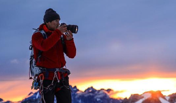 American mountaineer and the co-director of the film Free Solo, Jimmy Chin photographing mountains.