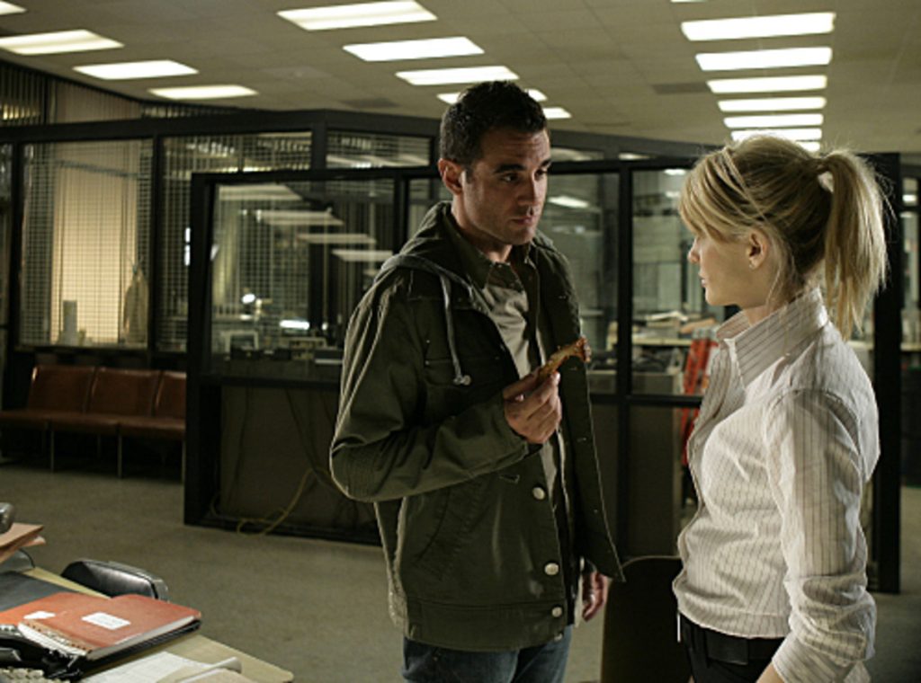 Kathryn Morris and Danny Pino having a serious talk in office in Cold Case