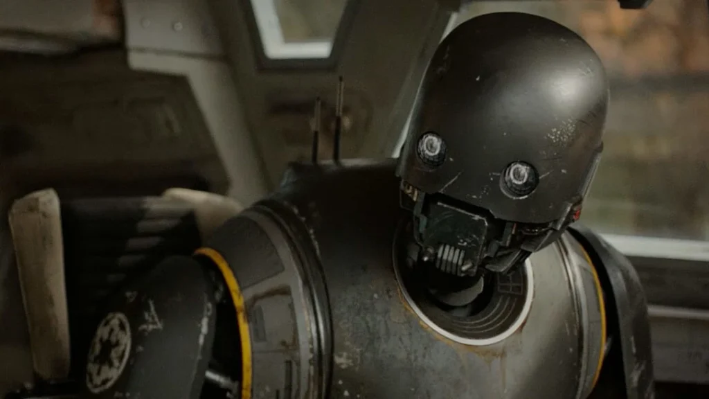 K-2SO, the Imperial security droid voiced by Alan Tudyk in Rogue One: A Star Wars Story, shown in his tall black droid form.