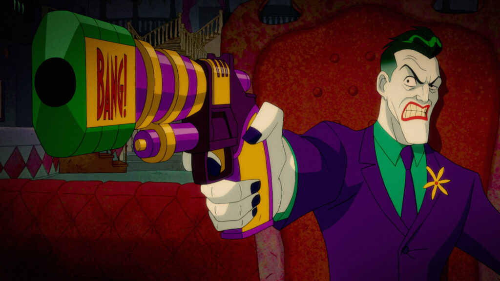 Joker from the Harley Quinn animated series, grinning menacingly while pointing a large green and purple gun with "BANG!" written on the barrel. The character has green hair, white skin, and is wearing his signature purple suit.