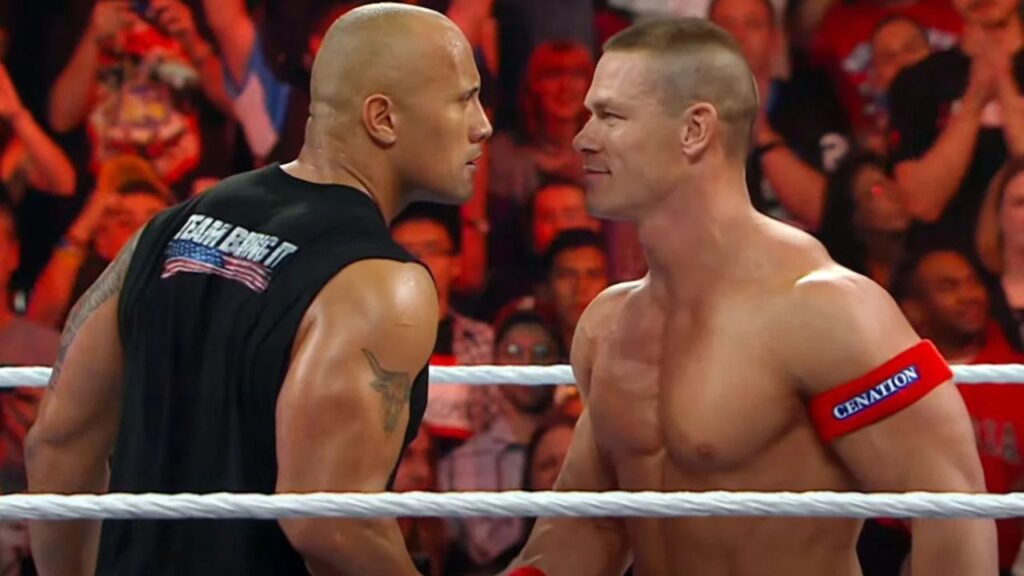 Dwyane 'The Rock' Johnson and John Cena shaking hands and staring each other in the WWE ring