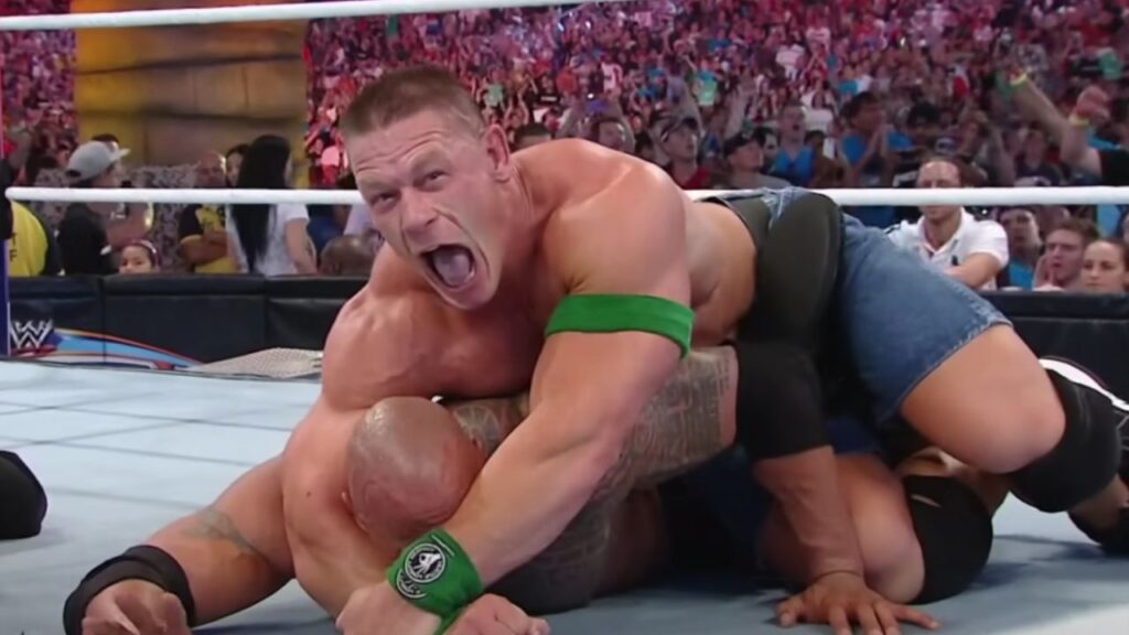 John Cena holding on to the submission on The Rock at WrestleMania 28