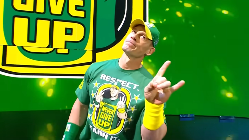 John Cena wearing a green "Never Give Up" t-shirt and yellow wristbands.