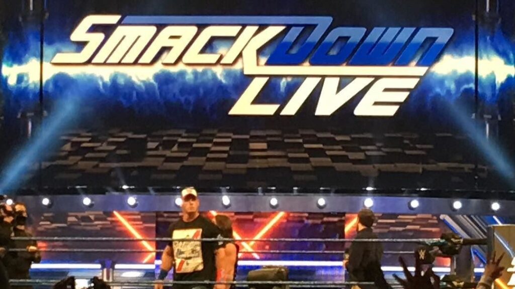 The SmackDown Live stage and set with John Cena visible in the ring during a WWE event.