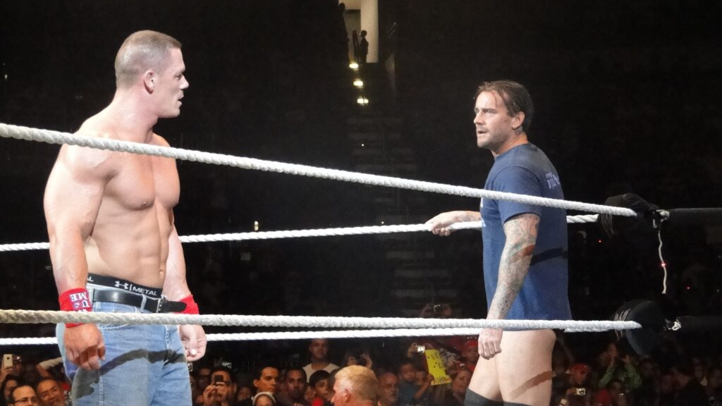 John Cena facing CM Punk in the ring.