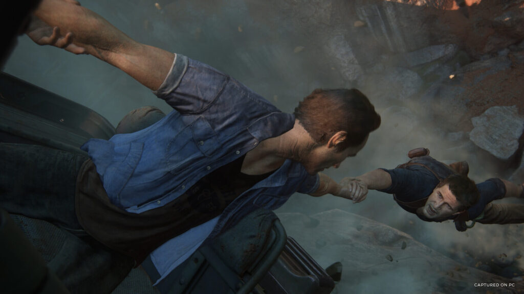 Uncharted 4 scene of protagonist Nathan Drake being saved from a fatal fall.