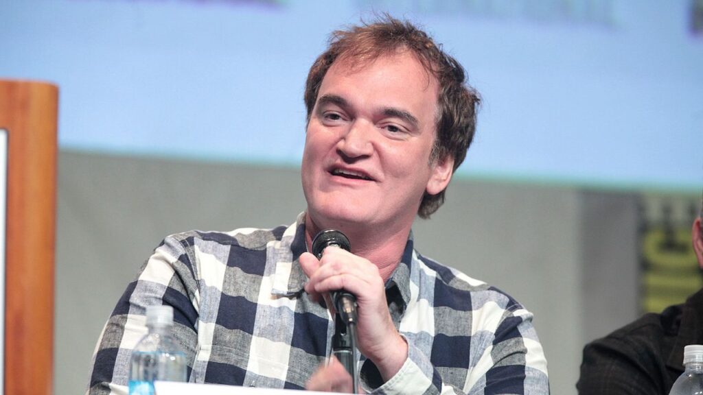 Quentin Tarantino holding the microphone while speaking at San Diego comic con