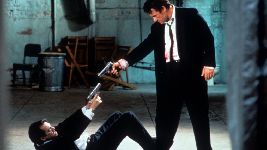 Steve Buscemi and Harvey Keitel pointing guns at each other in Reservoir Dogs