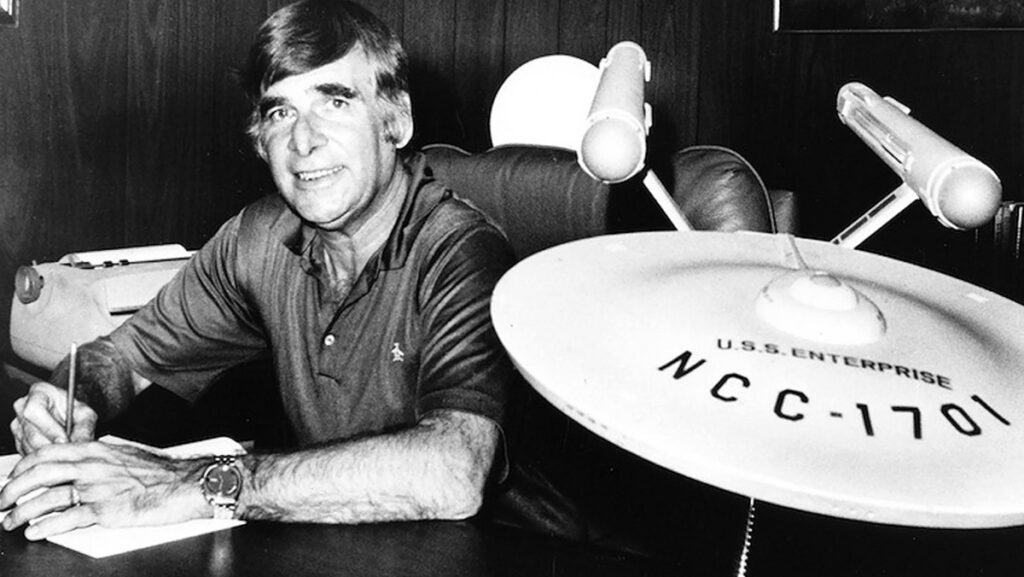 Gene Roddenberry in his office with a replica of the USS Enterprise