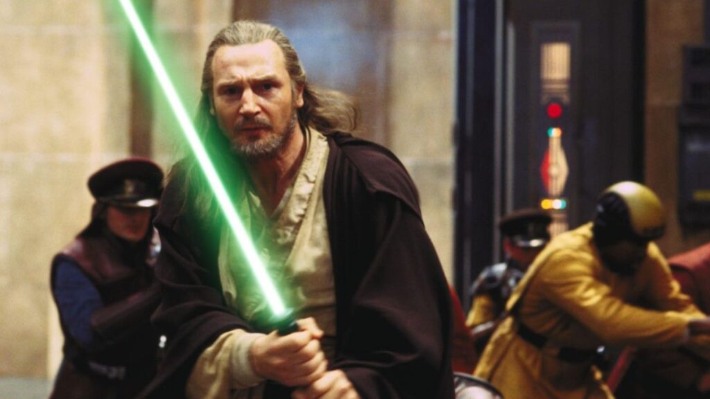 Liam Neeson holding a lightsaber in Star Wars: Episode I - The Phantom Menace