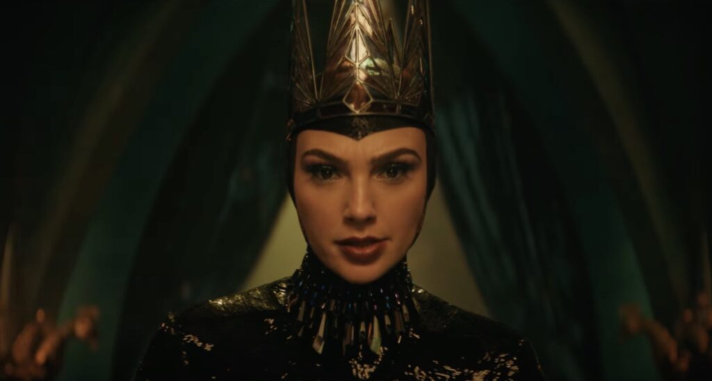 A close-up of Gal Gadot's face in Snow White showing her visage and costume as the Evil Queen