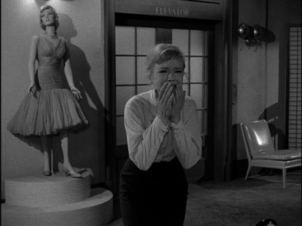 A shocked woman with hands on her mouth in a still from The Twilight Zone's episode After Hours