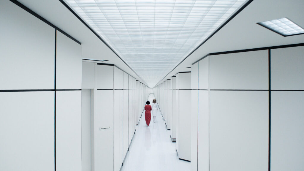 A still of a long white hallway from Severance season 2