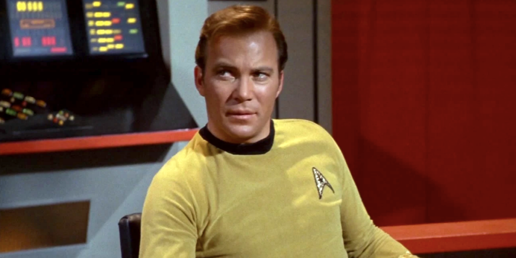 William Shatner as Captain Kirk of the USS Enterprise looking sideways at someone in Star Trek