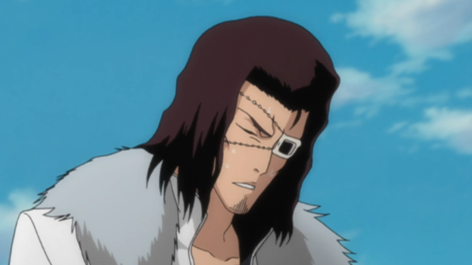 Starrk has one of his eyes covered with an eyepatch and has his head tilted downwards 