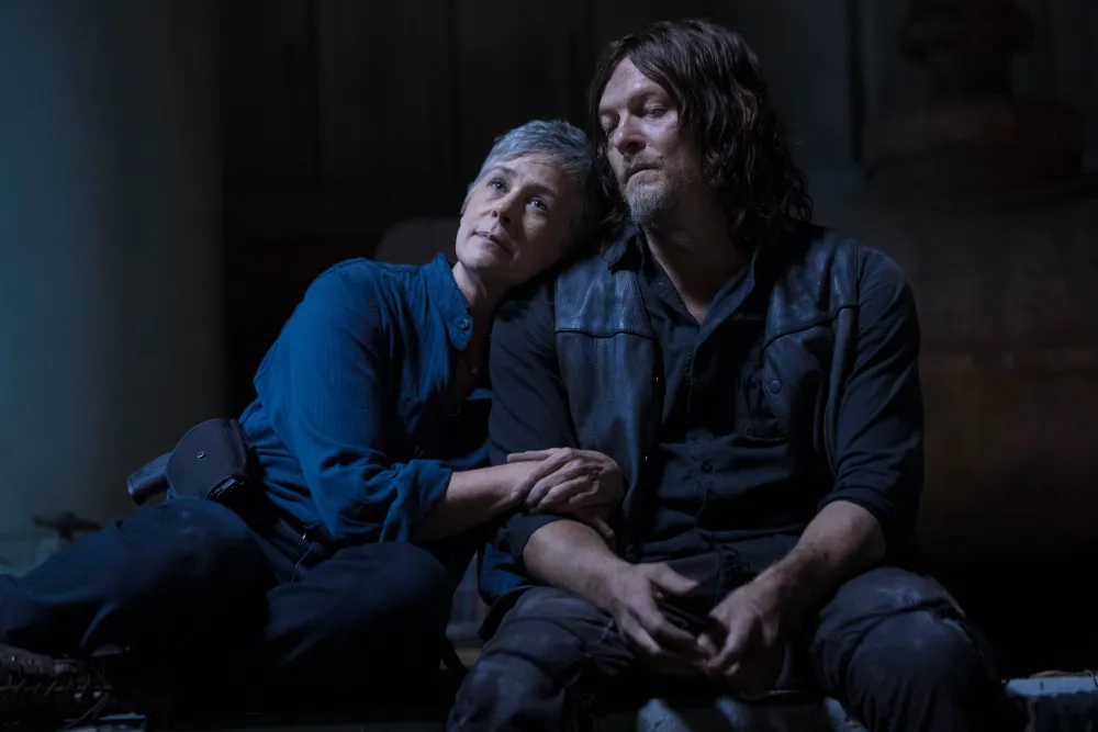 Melissa McBride putting her head on Norman Reedus' shoulder in The Walking Dead.