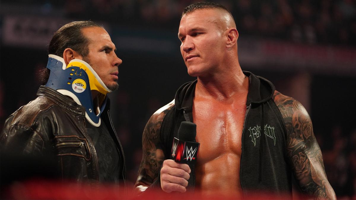 Matt Hardy in a neck brace and Randy Orton with a mic in hand.