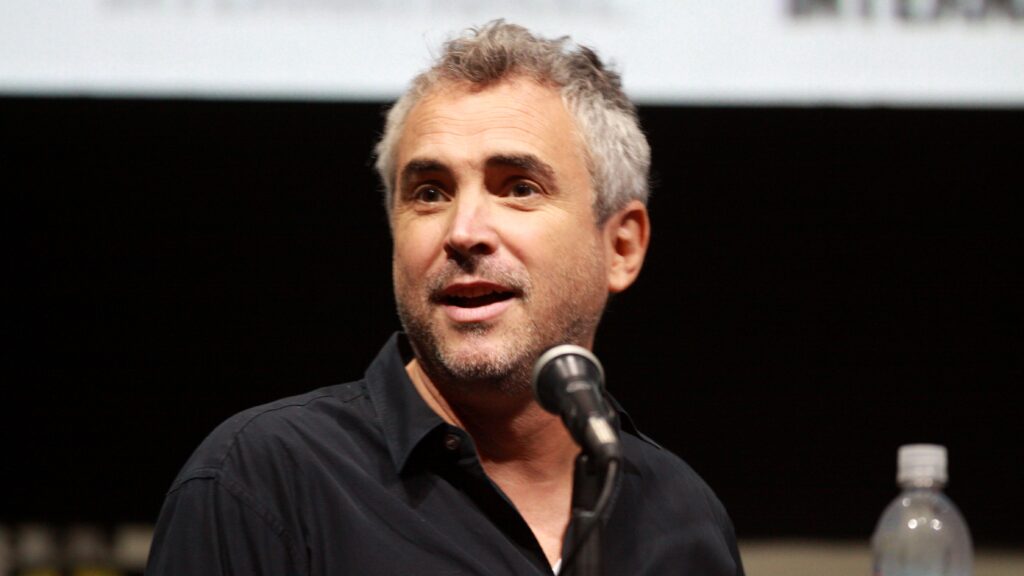 10 Most Successful Non-American Directors in Hollywood 3 Alfonso Cuarón speaking into a microphone at 2013 San Diego Comic Con International, for "Gravity." He's wearing a dark shirt and photographed against a dark background.