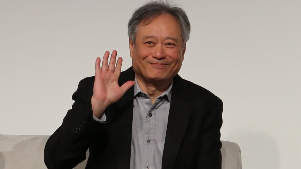 10 Most Successful Non-American Directors in Hollywood 5 Ang Lee wearing a black jacket over a gray shirt, waving at the camera. He's seated 2016 NAB Show's The Future of Cinema Conference.
