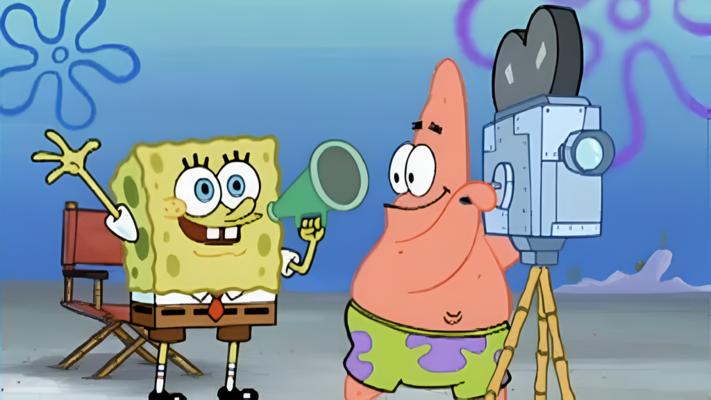 10 Most Successful Non-American Directors in Hollywood 12 An animated scene from SpongeBob SquarePants showing SpongeBob excitedly holding a megaphone while Patrick Star operates a vintage film camera.