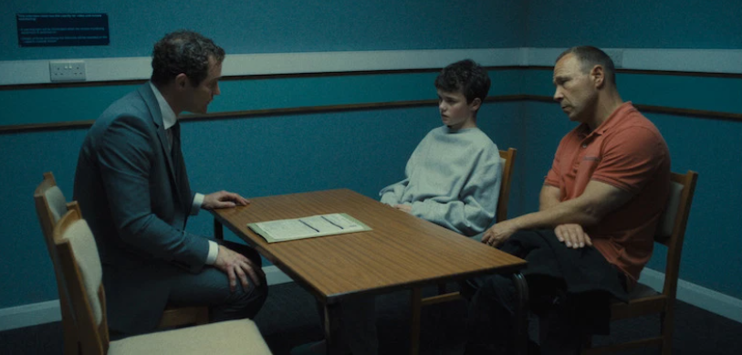 A still showing Jamie Miller getting advice from a solicitor in the presence of his father Eddie Miller in the series Adolescence.