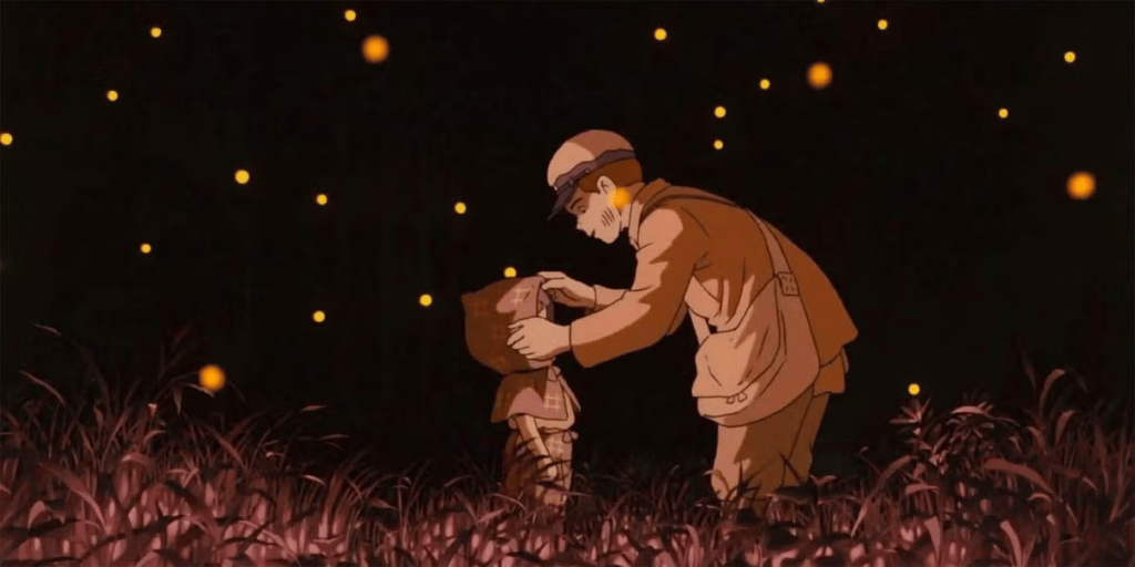 Seita putting Setsuko's hood on in while surrounded by fireflies in Grave of the Fireflies.
