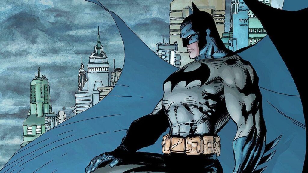 Bat man staring over the city from the top of a building