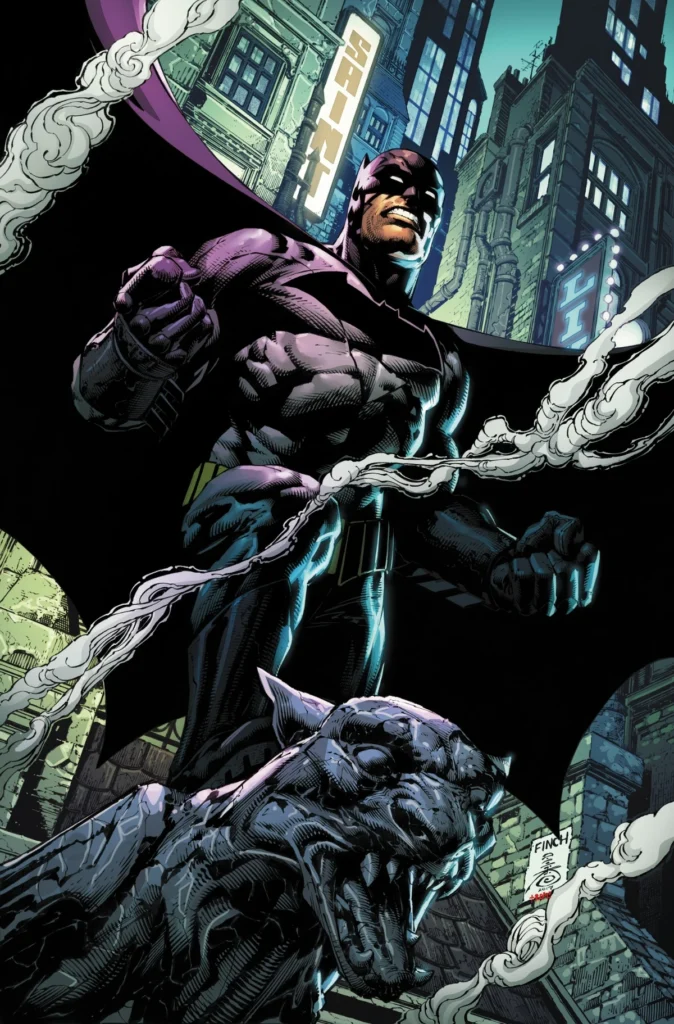 Batman posing on top of a concrete bat statue