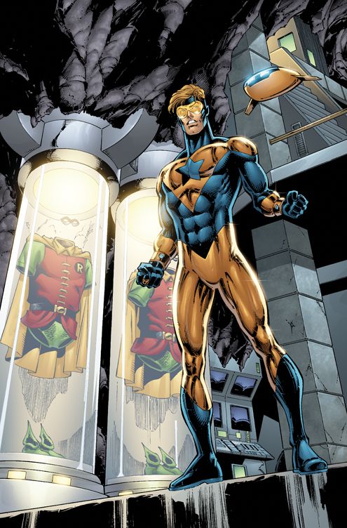 Booster Gold with a shocked expression and two Robin's outfit beside him inside a capsule