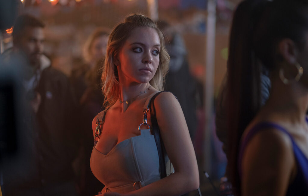 Sydney Sweeney Didn’t Like Filming Her S*x Scene in This 62% RT Horror Movie That’s Streaming on Prime 1 Sydney Sweeney looking over her shoulder with an almost smug look on her face in Euphoria.