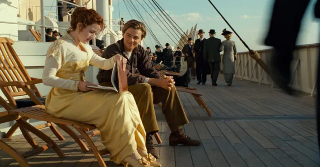Leonardo DiCaprio looking at Kate Winslet with love while she watches the paintings in Titanic