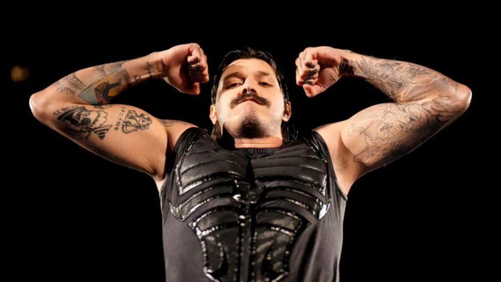 Dominik Mysterio flexing his arms