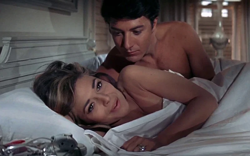 Dustin Hoffman in bed with Anne Bancroft in a still from The Graduate
