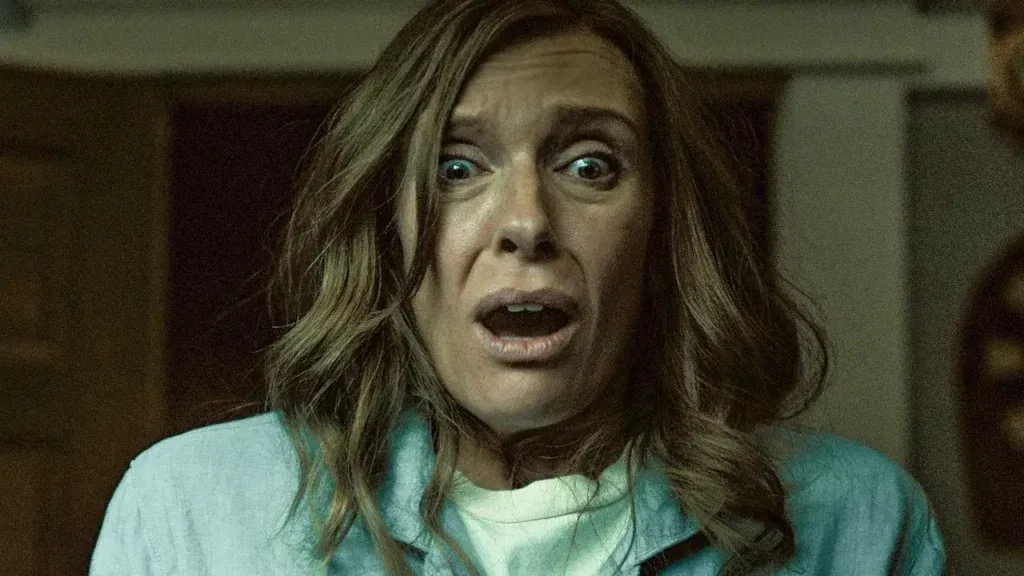 Toni Collette looking horrified in a still from Hereditary
